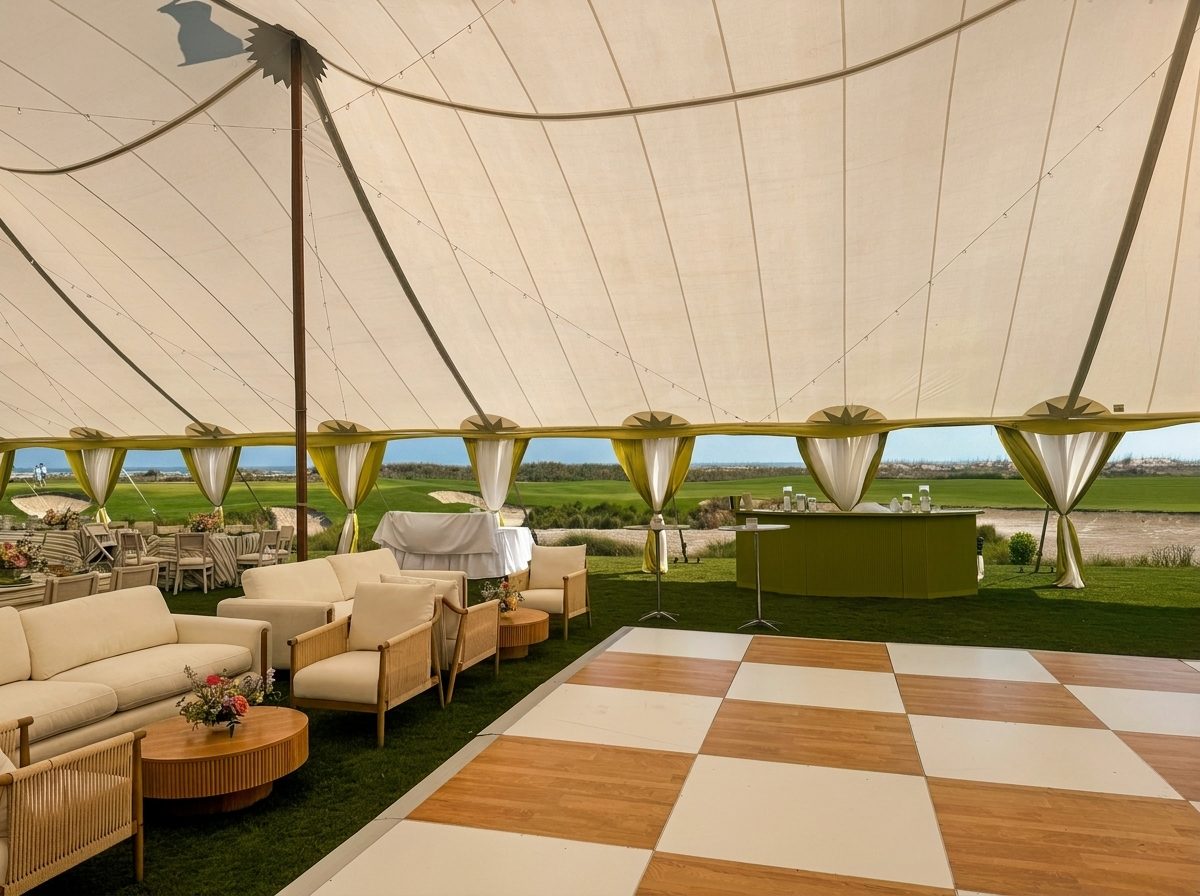Custom chartreuse-green bar and white lounge under a sailcloth tent with a checkered dance floor